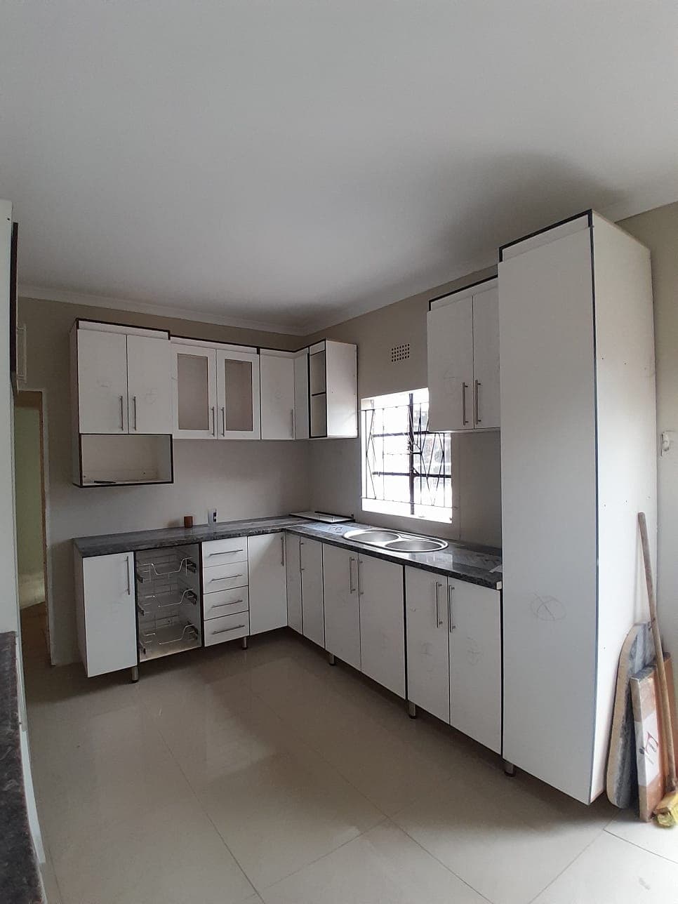 Custom kitchen cabinet installation by Kannjane Consultants, Komani